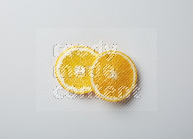 Two orange slices on white background