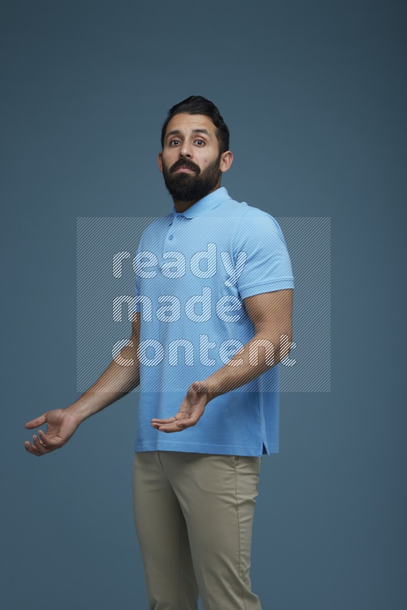 Man posing in a blue background wearing a Blue shirt