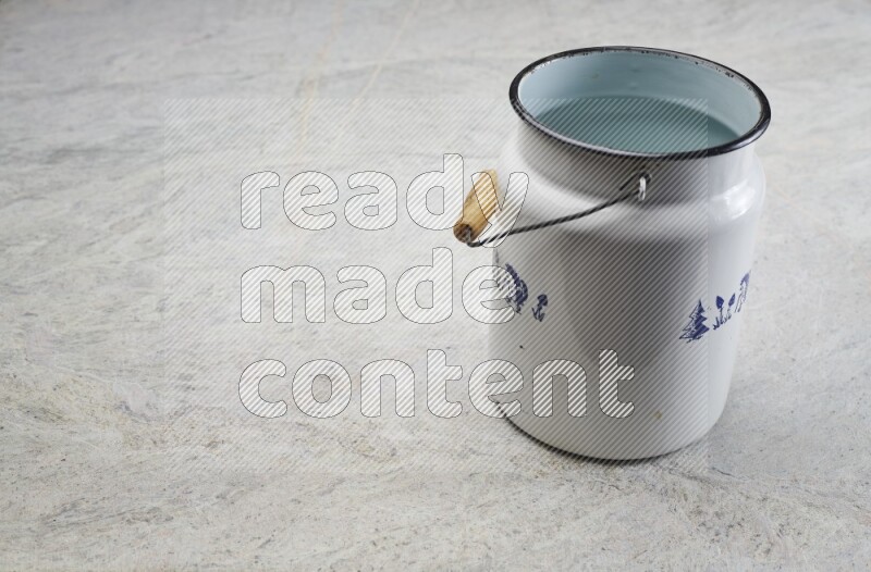 A vintage milk can on grey marble background