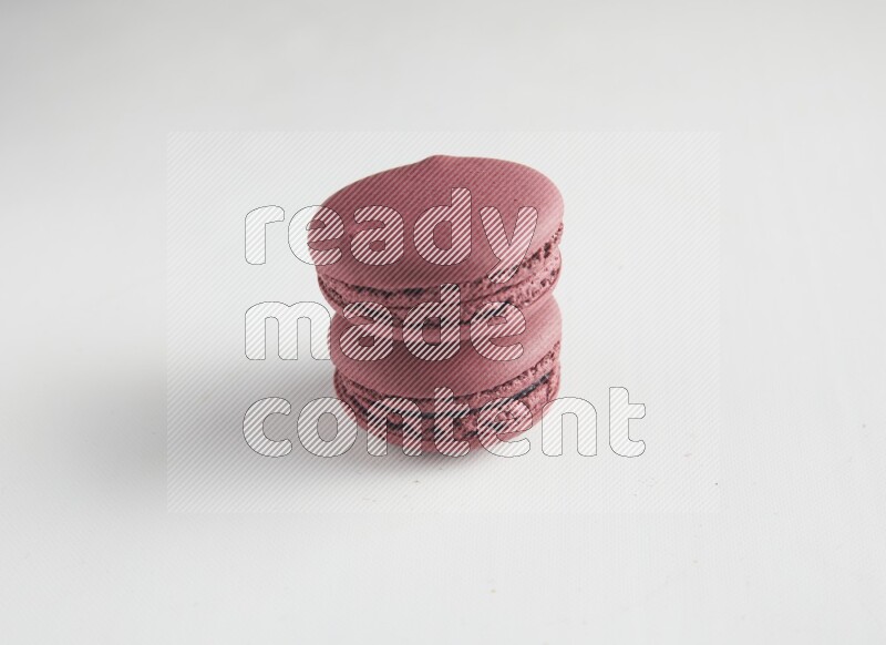 45º Shot of two Red Cherry macarons on white background