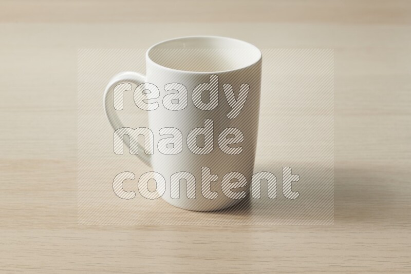 A white ceramic mug on light wooden background