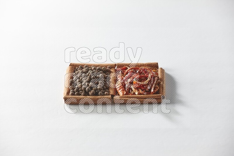 2 squares of cinnamon sticks full of dried red chilis and allspice on white flooring