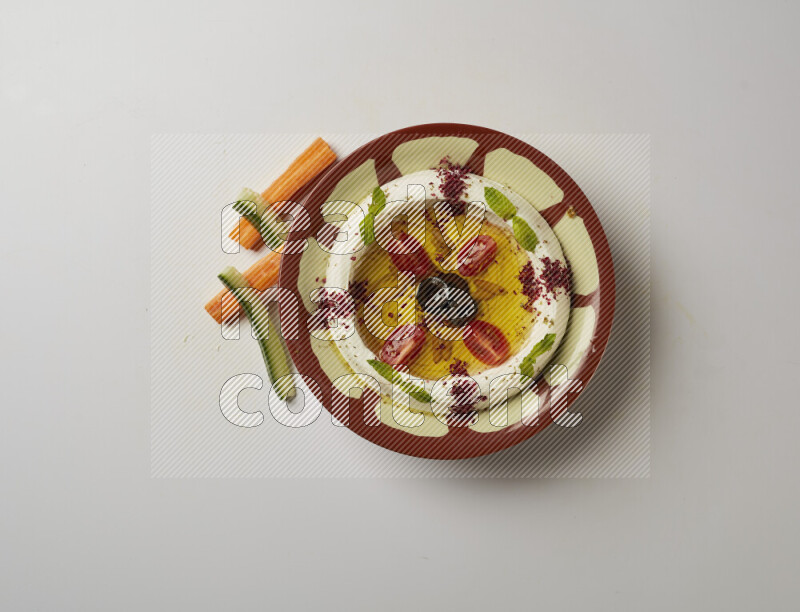 Lebnah garnished with Cherry tomato, mint & sumak  in a traditional plate on a white background