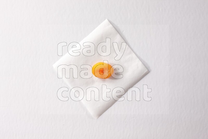 A dried apricot on a piece of paper on a white background in different angles