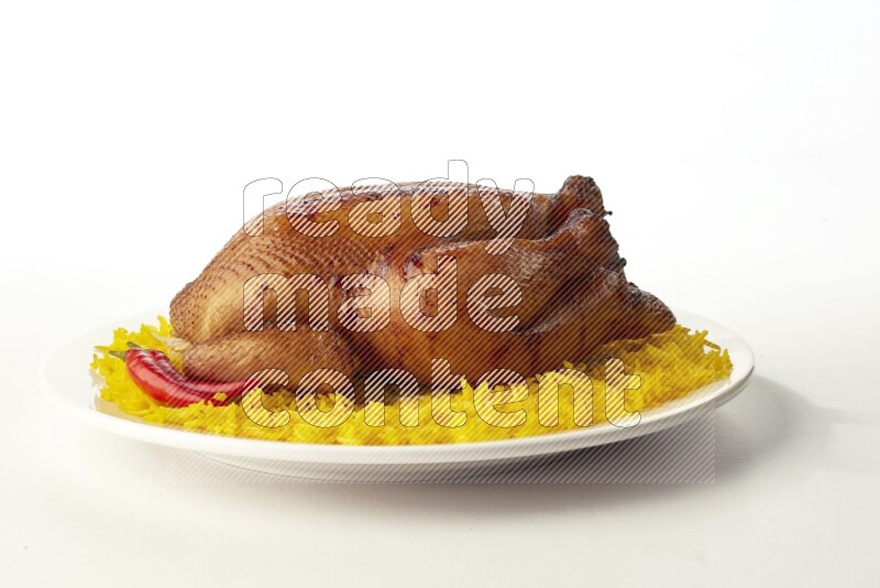 yellow  basmati Rice with  whole roasted chicken on a white rounded plate direct on white background
