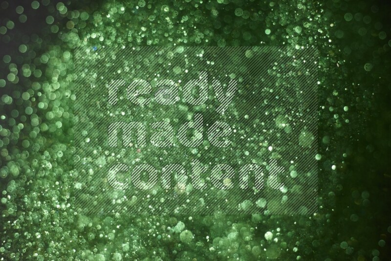 Green glitter powder isolated on black background