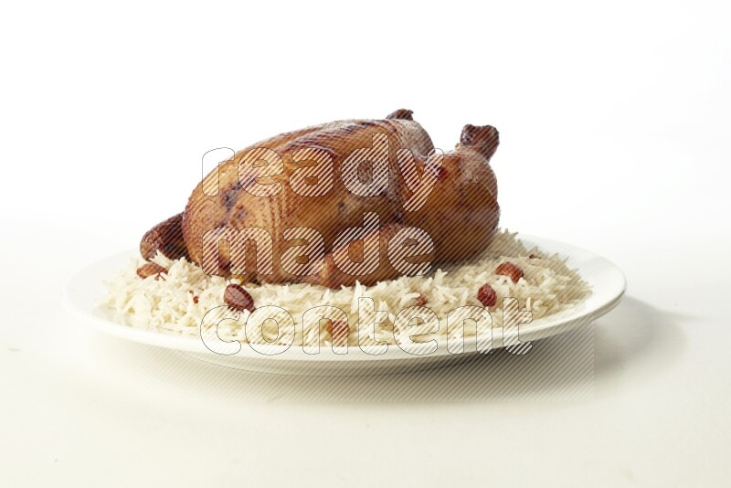 white  basmati Rice with  whole roasted chicken  on a white rounded plate direct on white background