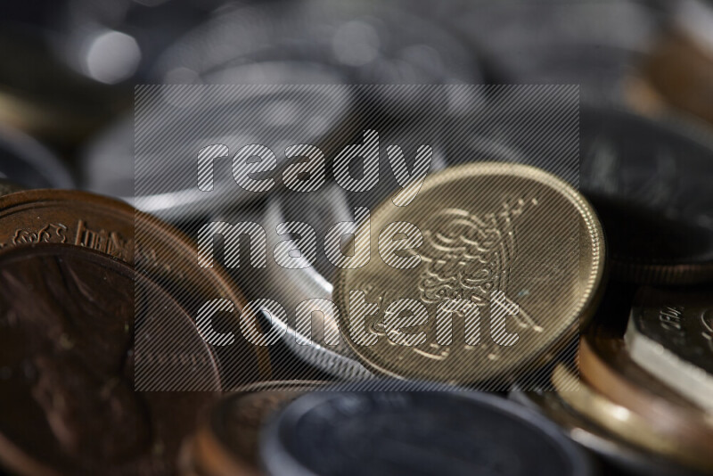 A close-ups of random old coins on black background