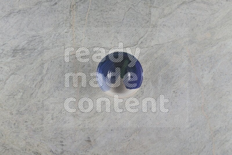 A multicolored pottery Bowl on grey marble background