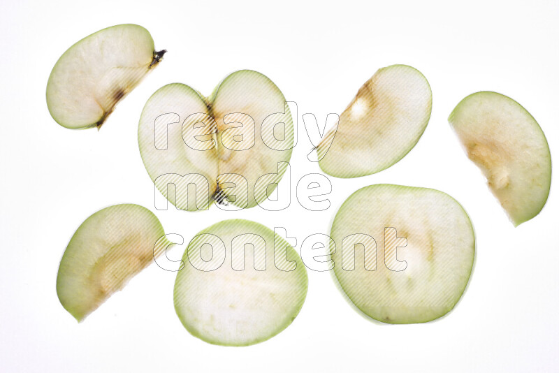 Apple slices on illuminated white background