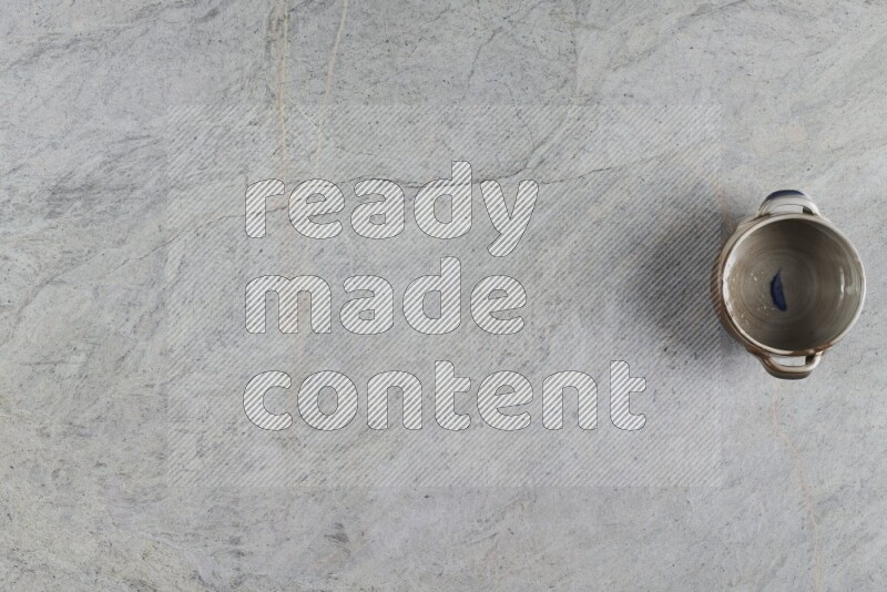 A multicolored pottery Bowl on grey marble background
