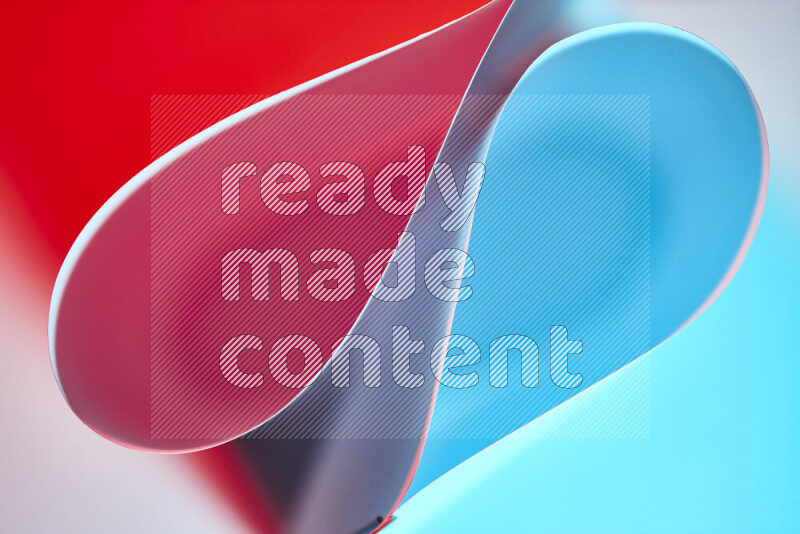 An abstract art of paper folded into smooth curves in blue and red gradients