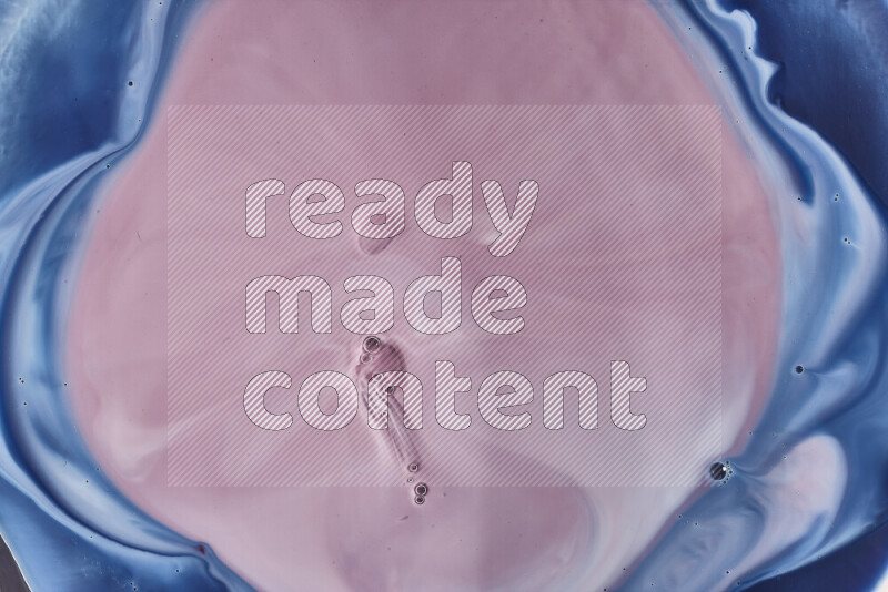 A close-up of abstract swirling patterns in blue, red and white