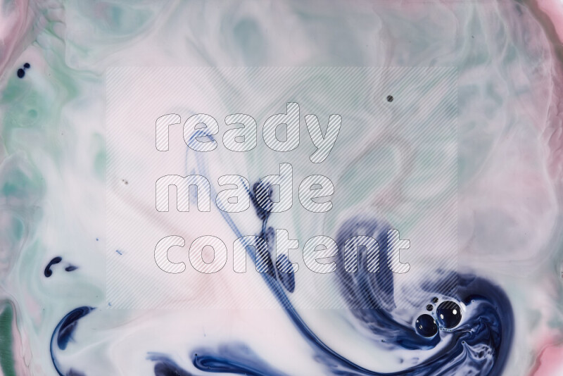 A close-up of abstract swirling patterns in red, green, white and blue