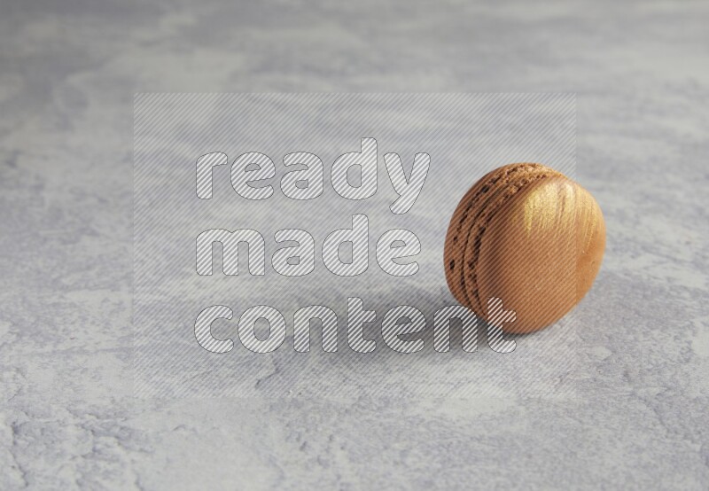 45º Shot of Brown Coffee macaron on white  marble background