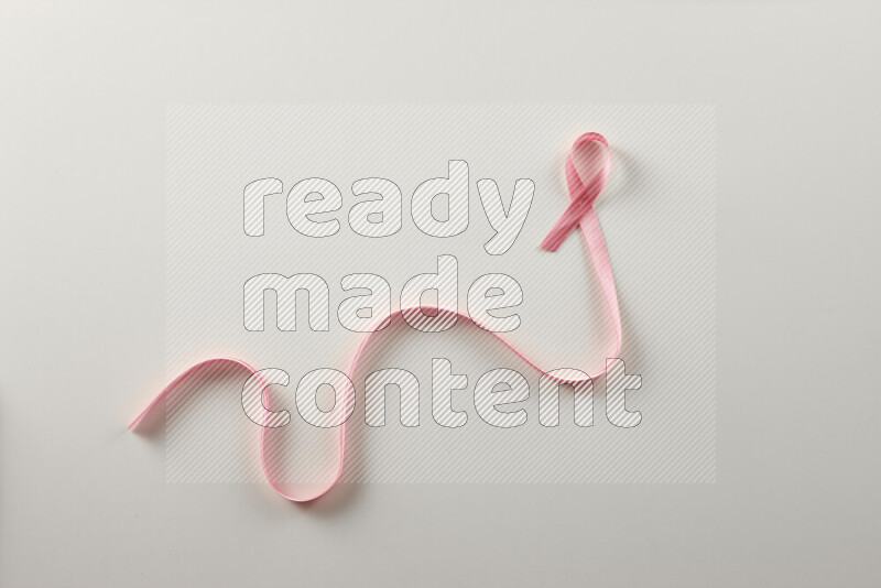 Pink ribbons on white background