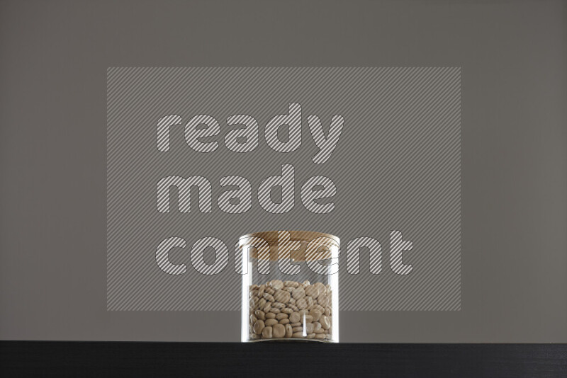 Lupin Beans in a glass jar on black background