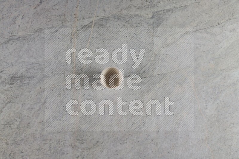 A multicolored pottery Cup on grey marble background