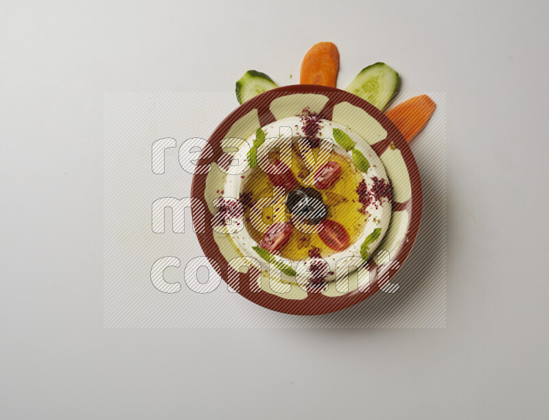 Lebnah garnished with Cherry tomato, mint & sumak  in a traditional plate on a white background