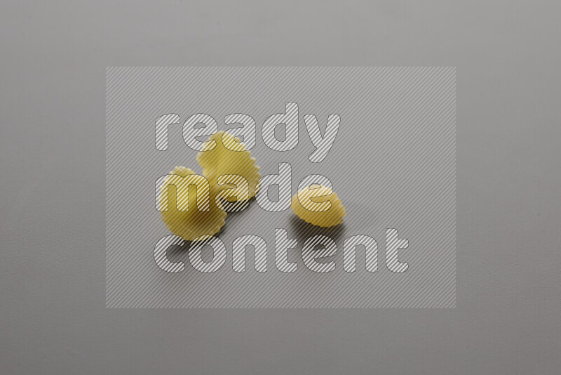 Fiocchi pasta with other types of pasta on grey background