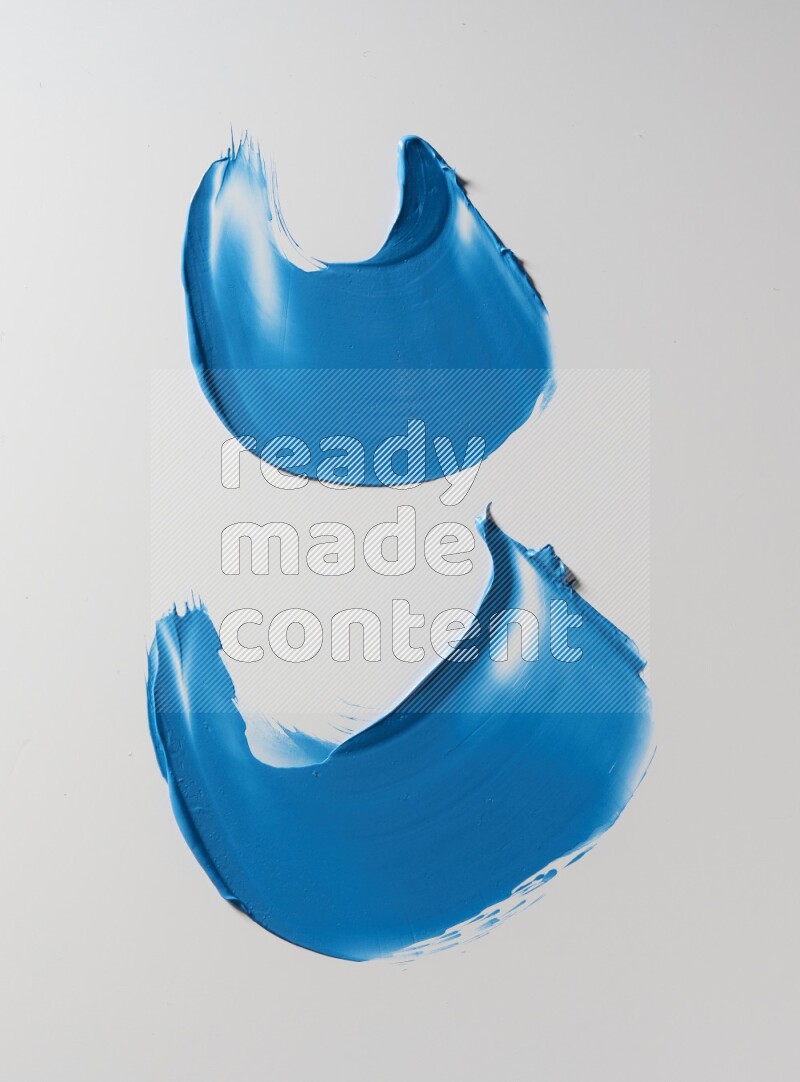 Blue curved painting knife strokes on white background