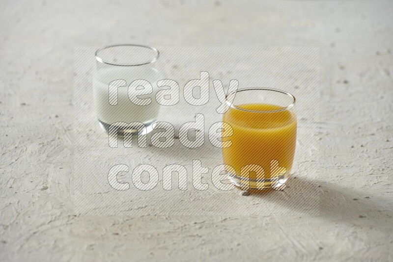 Cold drinks in a glass cup such as water, tamarind, qamar eldin, sobia, milk and hibiscus on textured white background