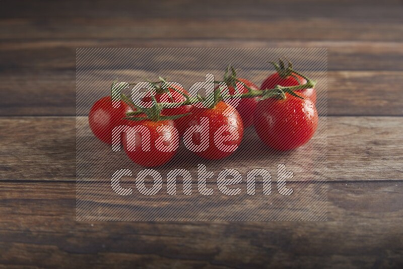 Red cherry tomato vein on a textured wooden background 45 degree