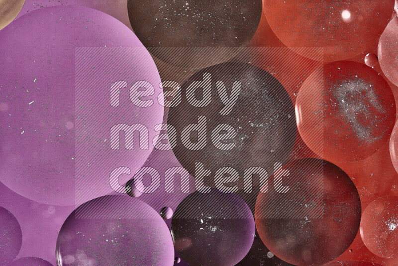 Close-ups of abstract oil bubbles on water surface in shades of brown, orange and purple