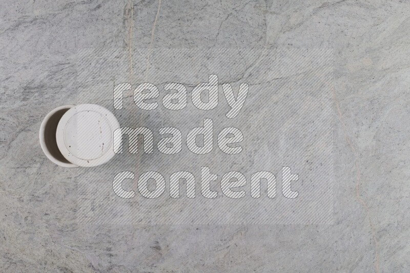 A multicolored pottery Cup on grey marble background