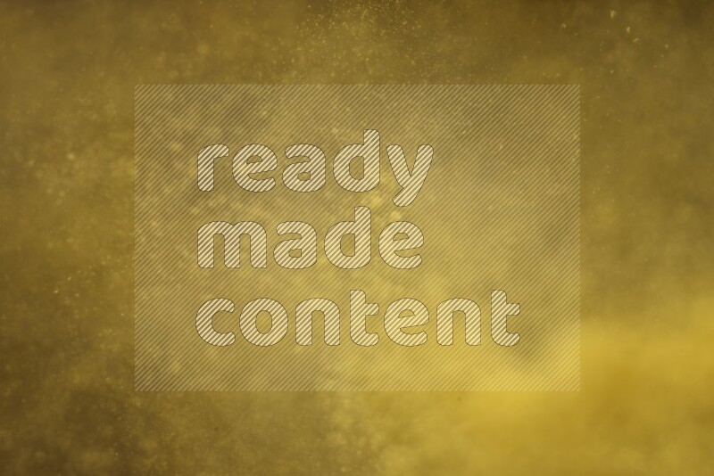 Yellow powder explosion on black background