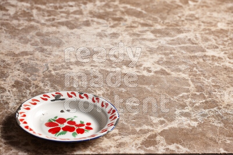 A vintage metal plate on beige marble background