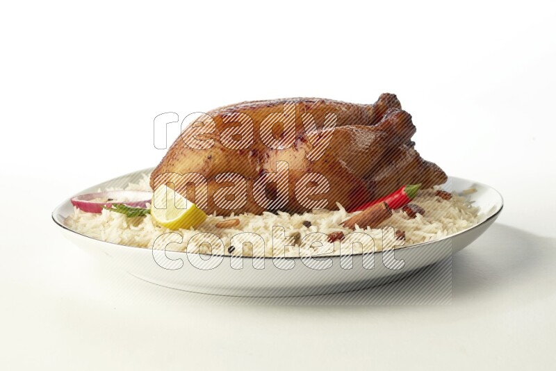 white  basmati Rice with  whole roasted chicken  on a white plate with a silver rim direct  on white background