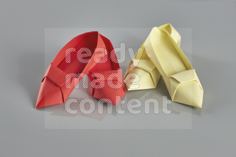 Origami shoes on grey background