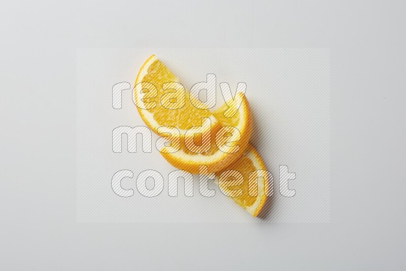Three halves of an orange slices on white background