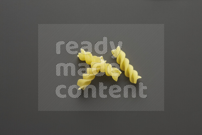 Fusilli pasta on grey background