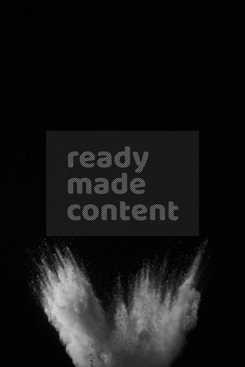 A side view of white powder explosion on black background
