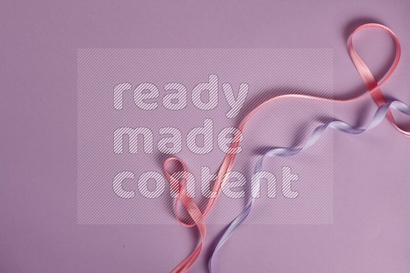 A pink and purple collection of sewing and tailoring tools arranged on a purple background