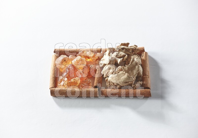 2 squares of cinnamon sticks full of dried ginger and gum arabic on white flooring