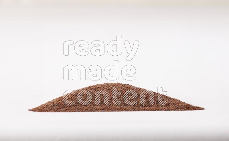 Garden cress seeds in a triangle shape on a white flooring