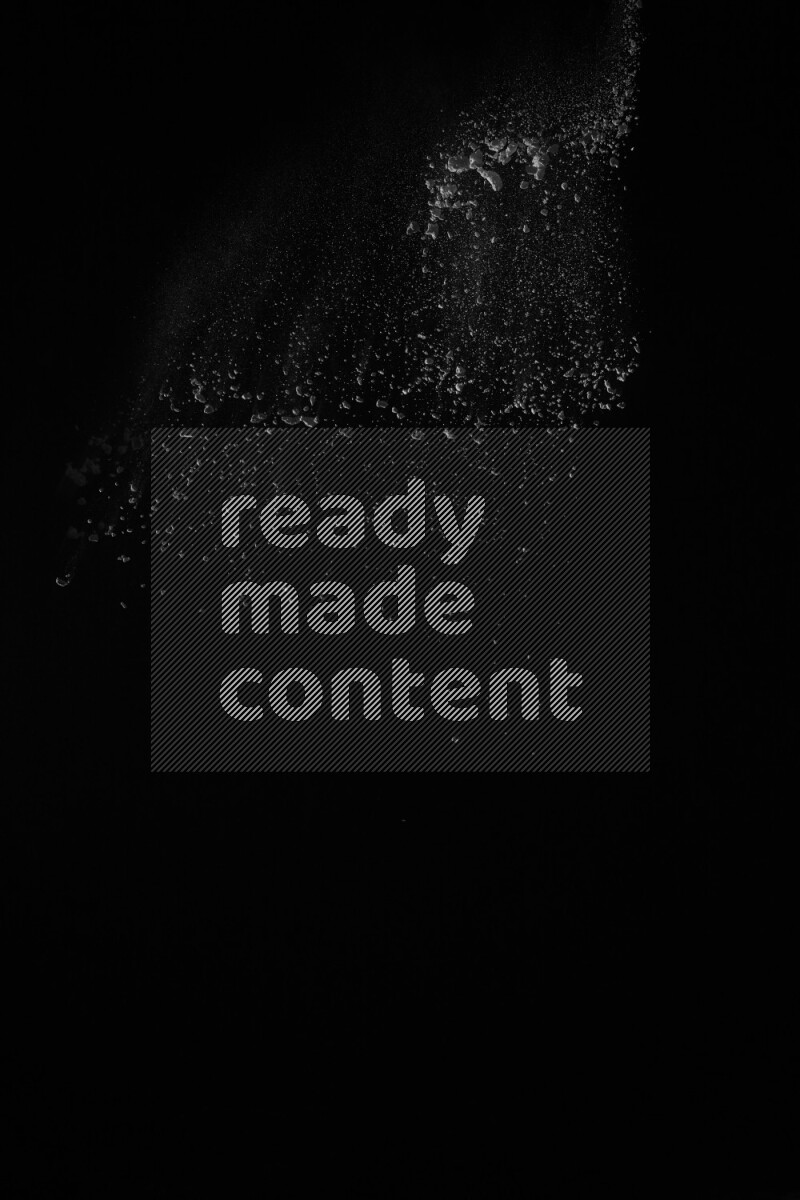 A side view of white powder explosion on black background