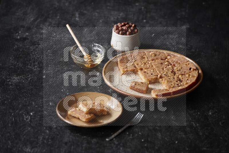 Basbousa with nuts and honey in a dark setup