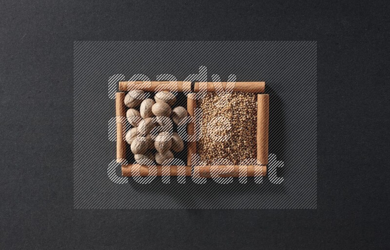 2 squares of cinnamon sticks full of mustard seeds and nutmeg on black flooring