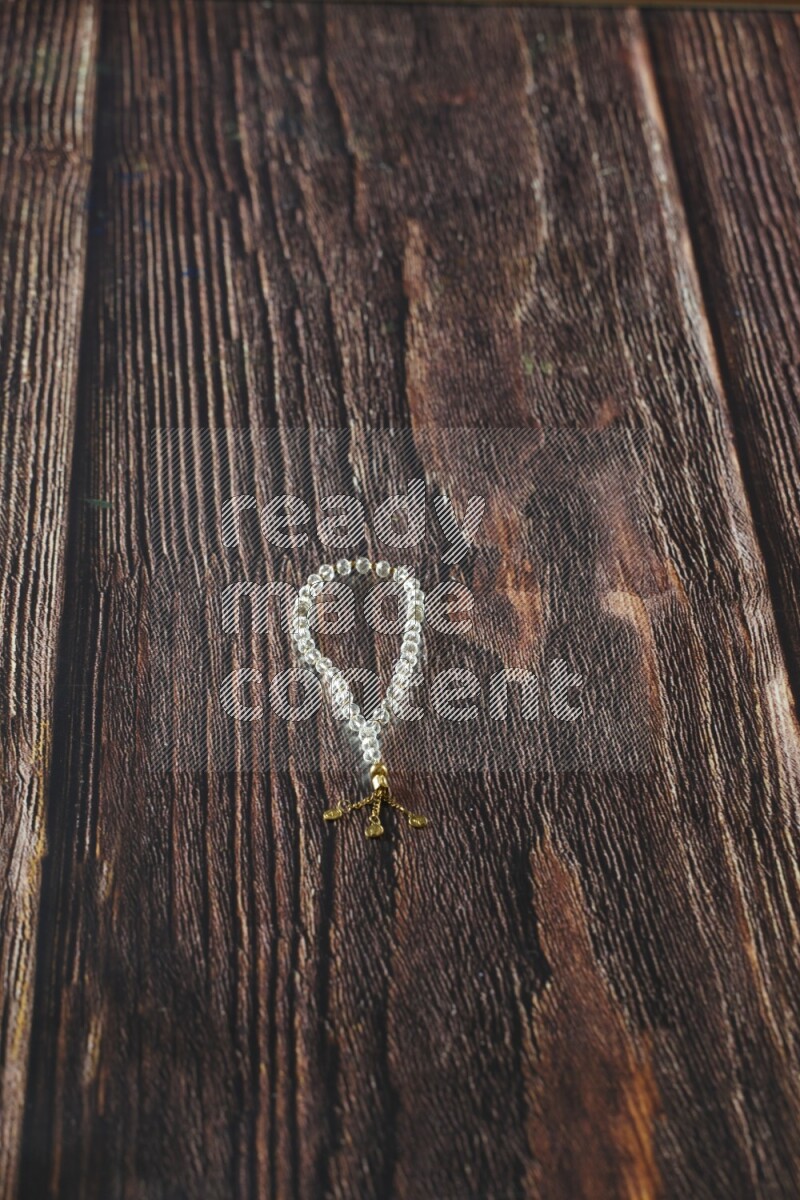 A prayer beads placed on wooden background