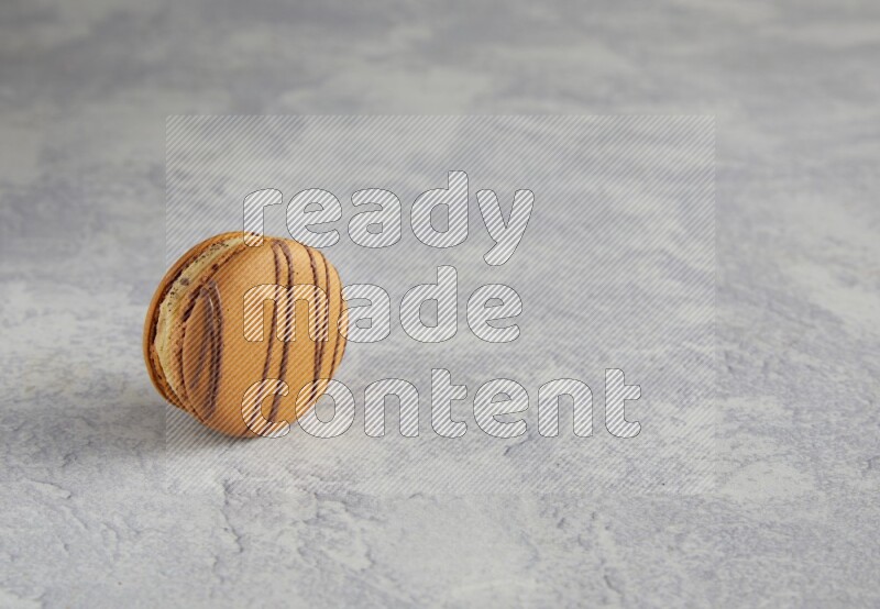 45º Shot of light brown  Almond Cream macaron on white  marble background