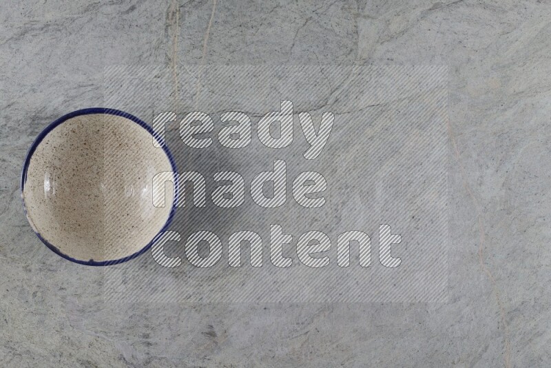A multicolored pottery Bowl on grey marble background