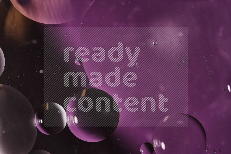 Close-ups of abstract oil bubbles on water surface in shades of purple