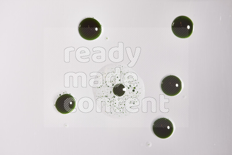 Close-ups of abstract green paint droplets on the surface