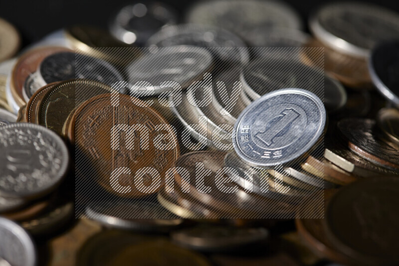 A close-ups of random old coins on black background