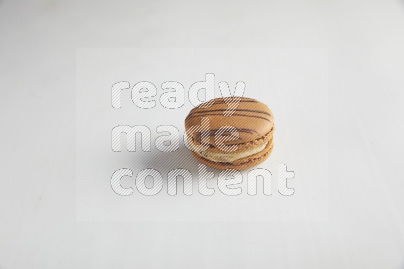 45º Shot of light brown  Almond Cream macaron on white background
