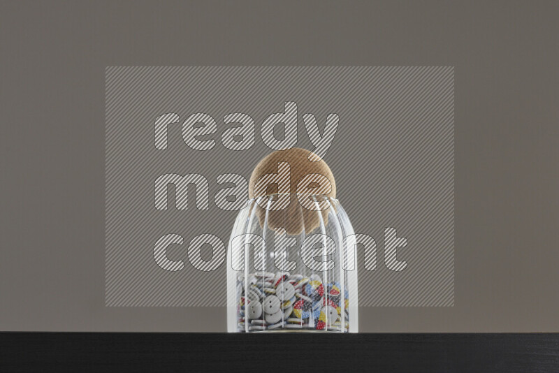 Buttons in a glass jar on black background